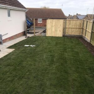 Indian Sandstone Patio with Railway Sleepers and New Lawn in…