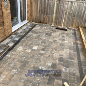 Patio with Retaining Sleeper Wall in Ashford