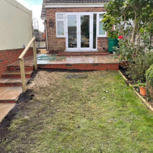 Raised Indian Sandstone Patio with Brick Retaining Wall and Steps…