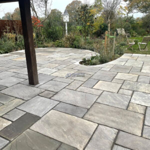 Raised Indian Sandstone Patio with Brick Wall and Steps in…