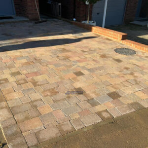 Tegula Paved Driveway with Brick Wall in Tunbridge Wells