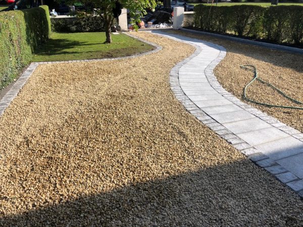 Gravel being laid on a driveway in Acrise