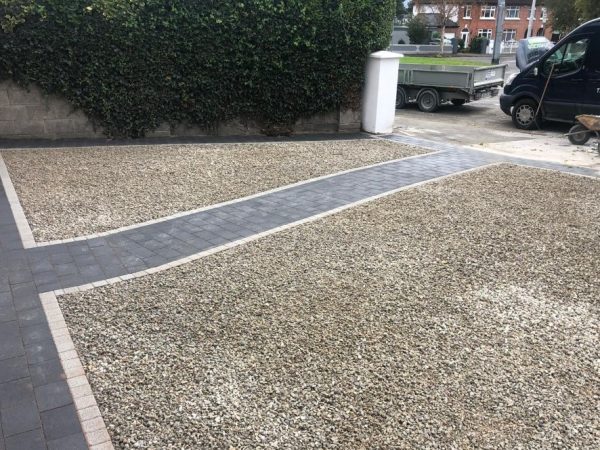 Gravel being laid on a driveway in Addington