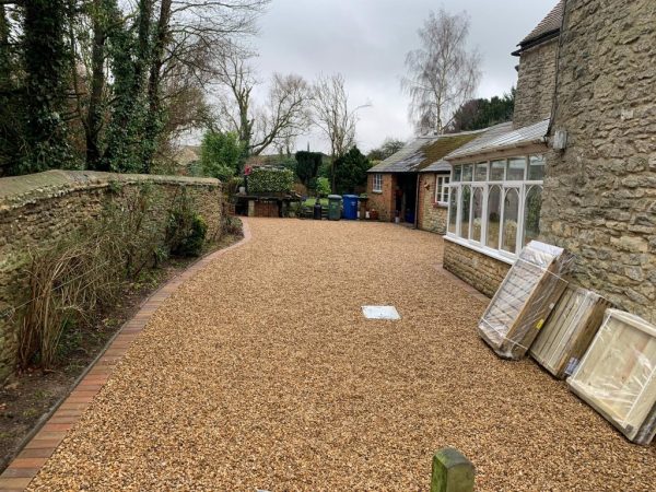 Gravel being laid on a driveway in Bicknor