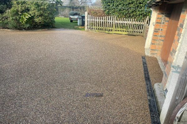 Resin surfacing installation on a driveway in Acrise