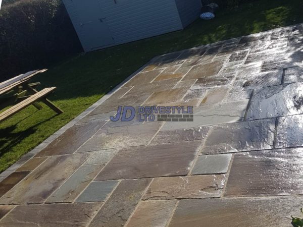 Sandstone patio installation in Acrise