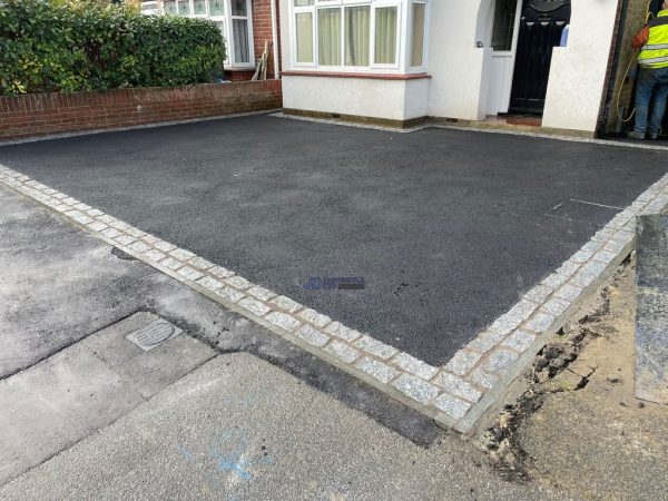 New driveway with tarmac and granite stone border in Acrise